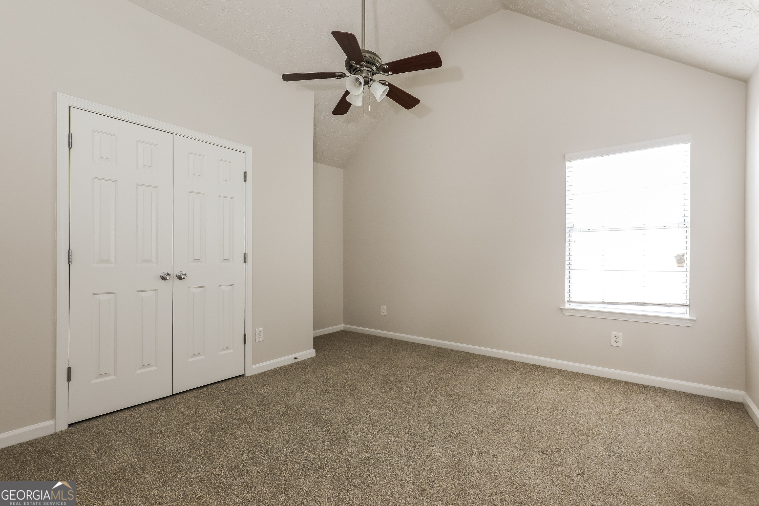 7812 Bell Tower Lane Fairburn, GA 30213 - Photo 11 of 17 an empty room with a window and a fan