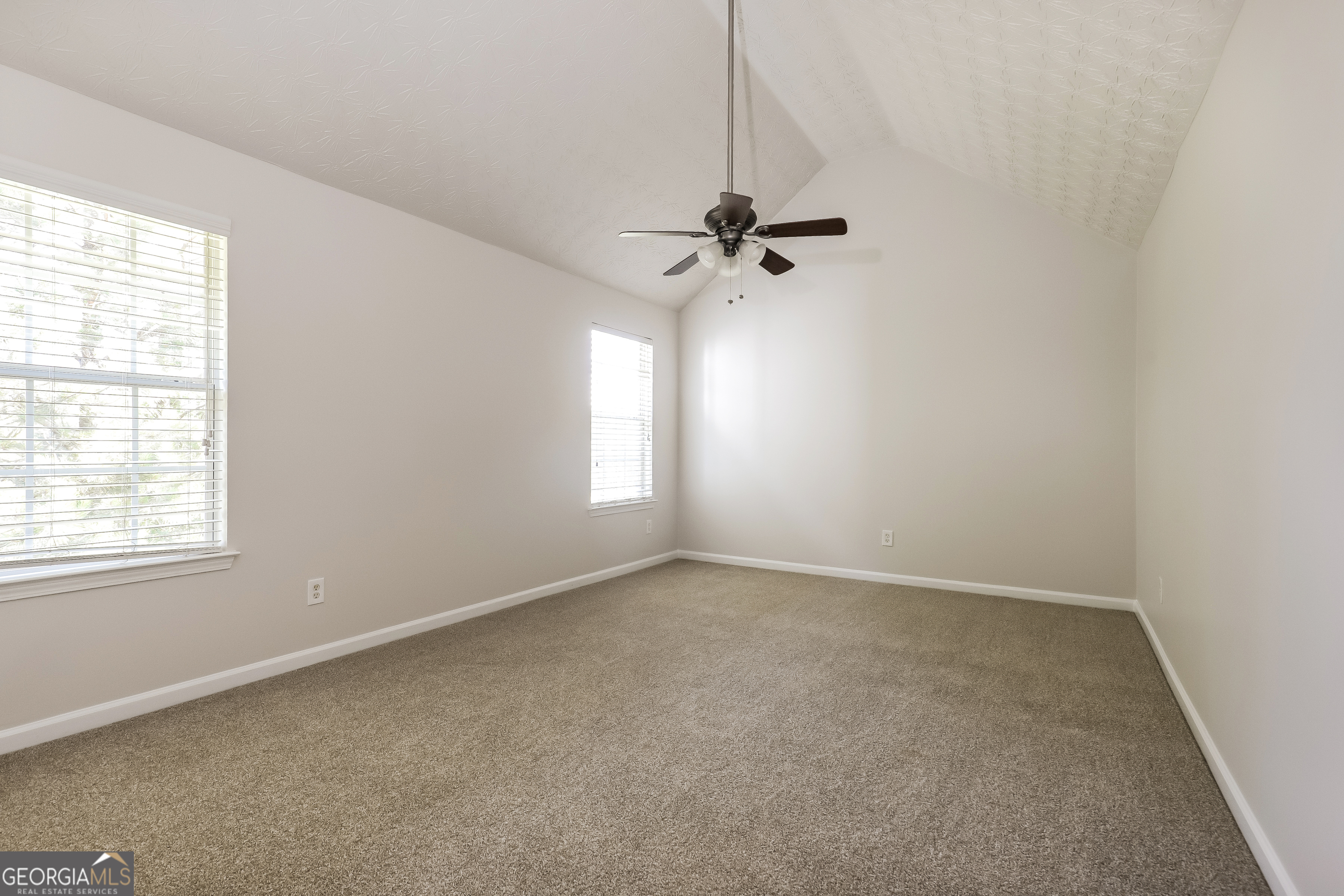7812 Bell Tower Lane Fairburn, GA 30213 - Photo 12 of 17 a view of room with a ceiling fan and window