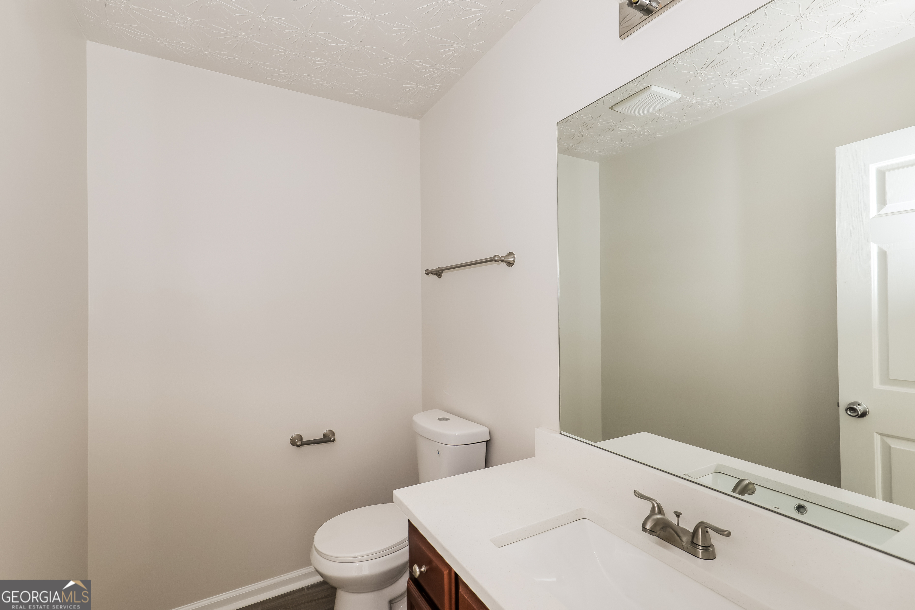 7812 Bell Tower Lane Fairburn, GA 30213 - Photo 14 of 17 a bathroom with a sink and a toilet