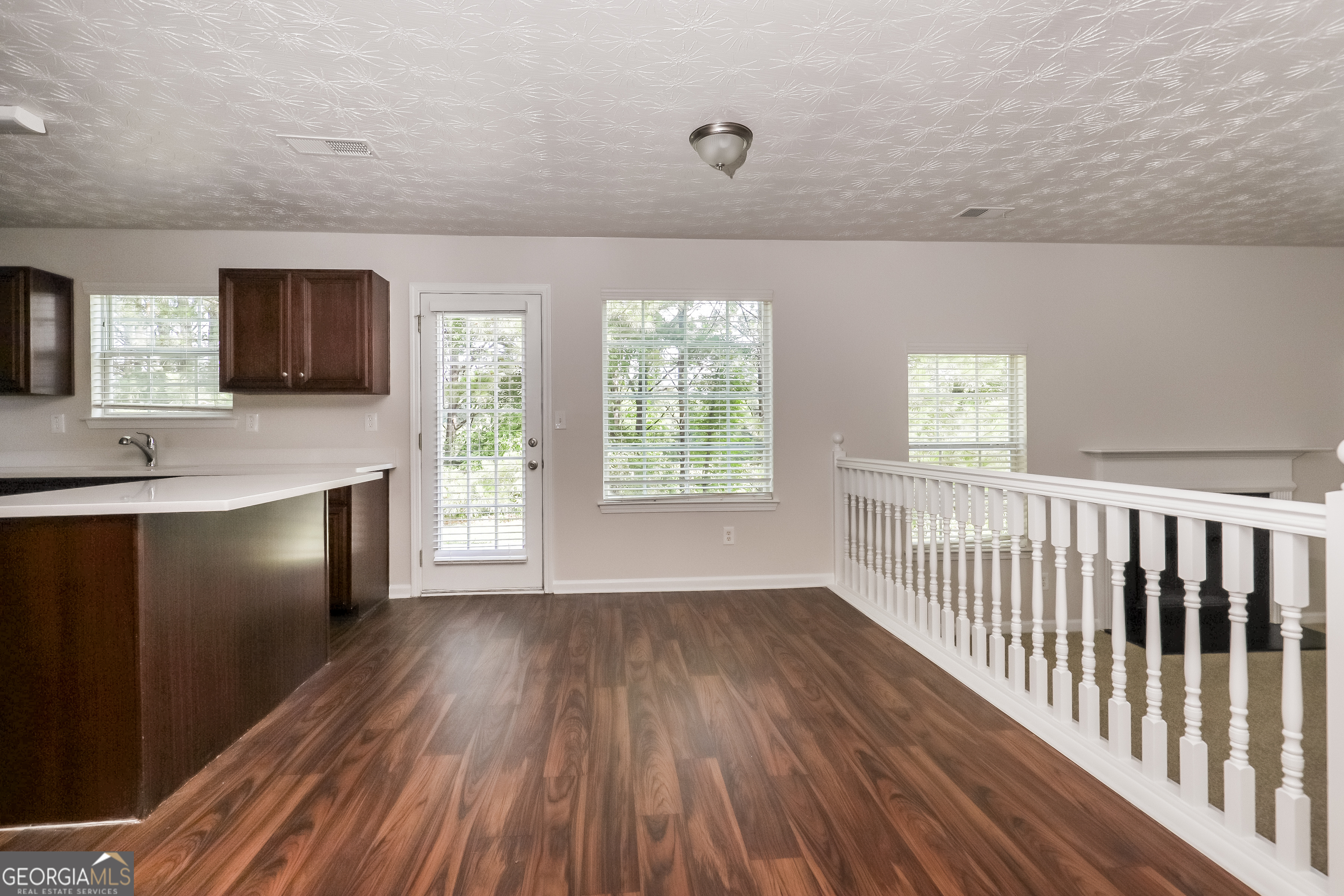 7812 Bell Tower Lane Fairburn, GA 30213 - Photo 5 of 17 a view of a kitchen with wooden floor and a window