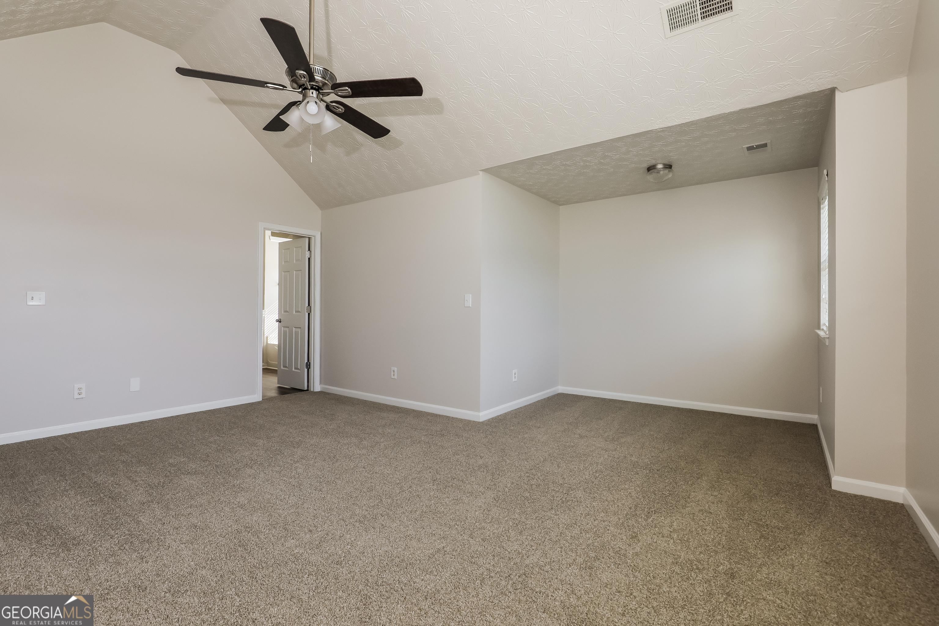 7812 Bell Tower Lane Fairburn, GA 30213 - Photo 9 of 17 a view of a room with a ceiling fan