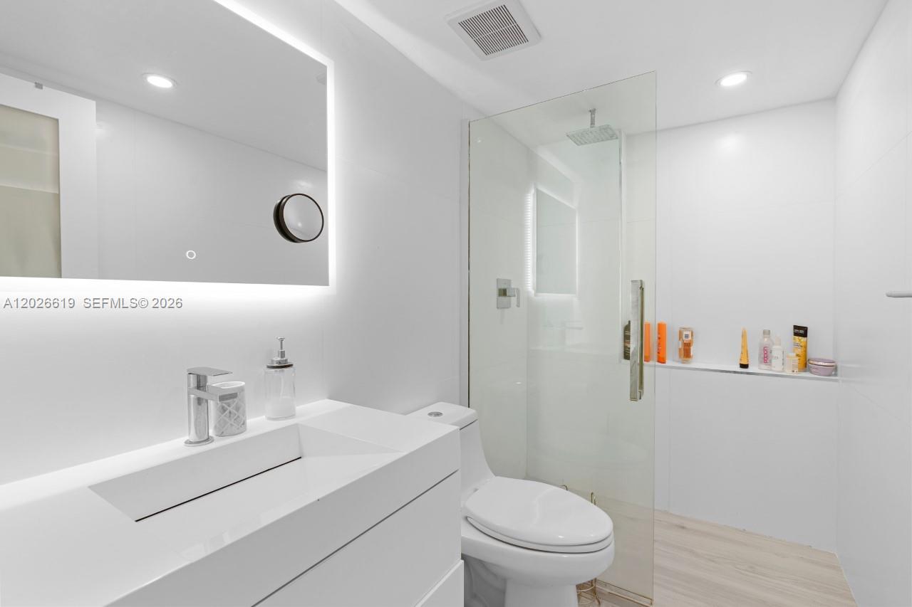 1500 Bay Road, Unit 1268S Miami Beach, FL 33139 - Photo 4 of 31 a bathroom with a sink a toilet and shower