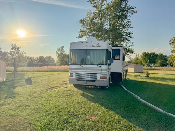 a backyard of a house with a yard and outdoor seating