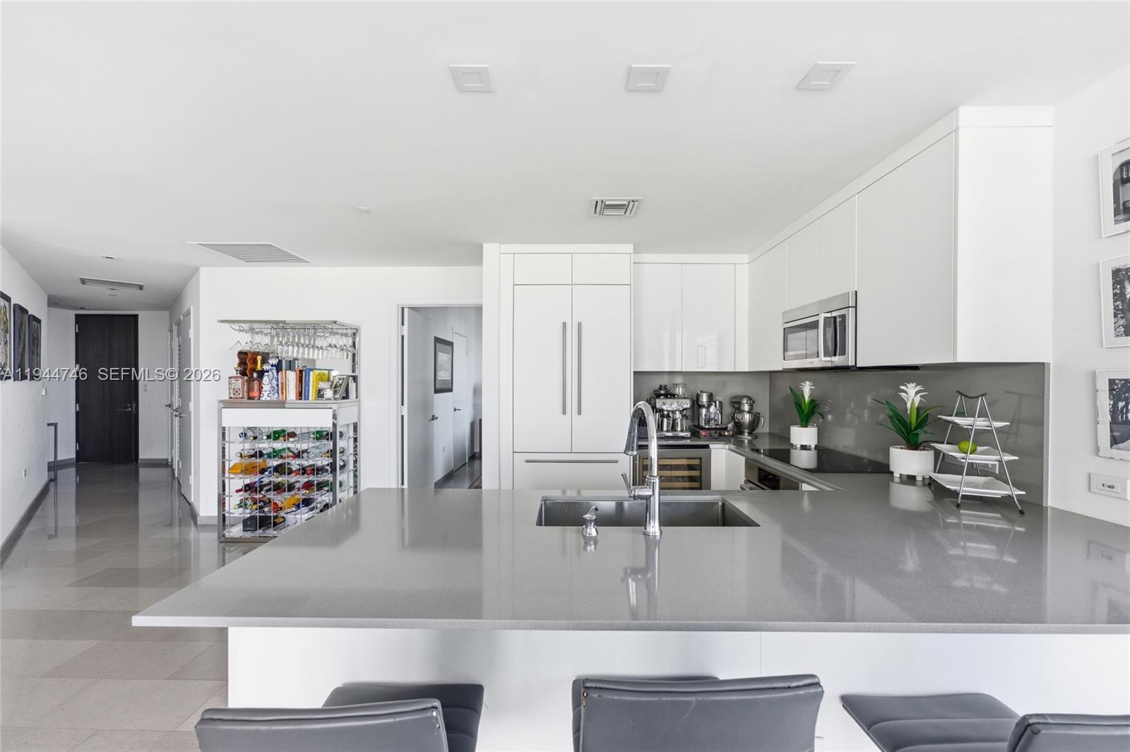 88 Southwest 7th Street, Unit 2302 Miami, FL 33130 - Photo 11 of 43 a living room with furniture and a kitchen view