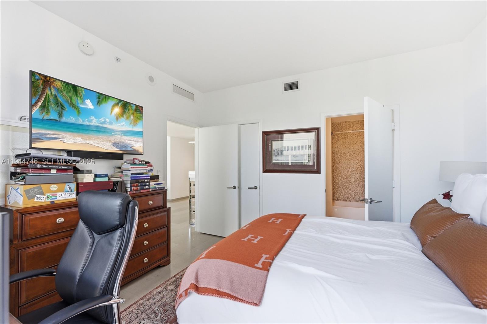 88 Southwest 7th Street, Unit 2302 Miami, FL 33130 - Photo 19 of 43 a bedroom with furniture and flat screen tv