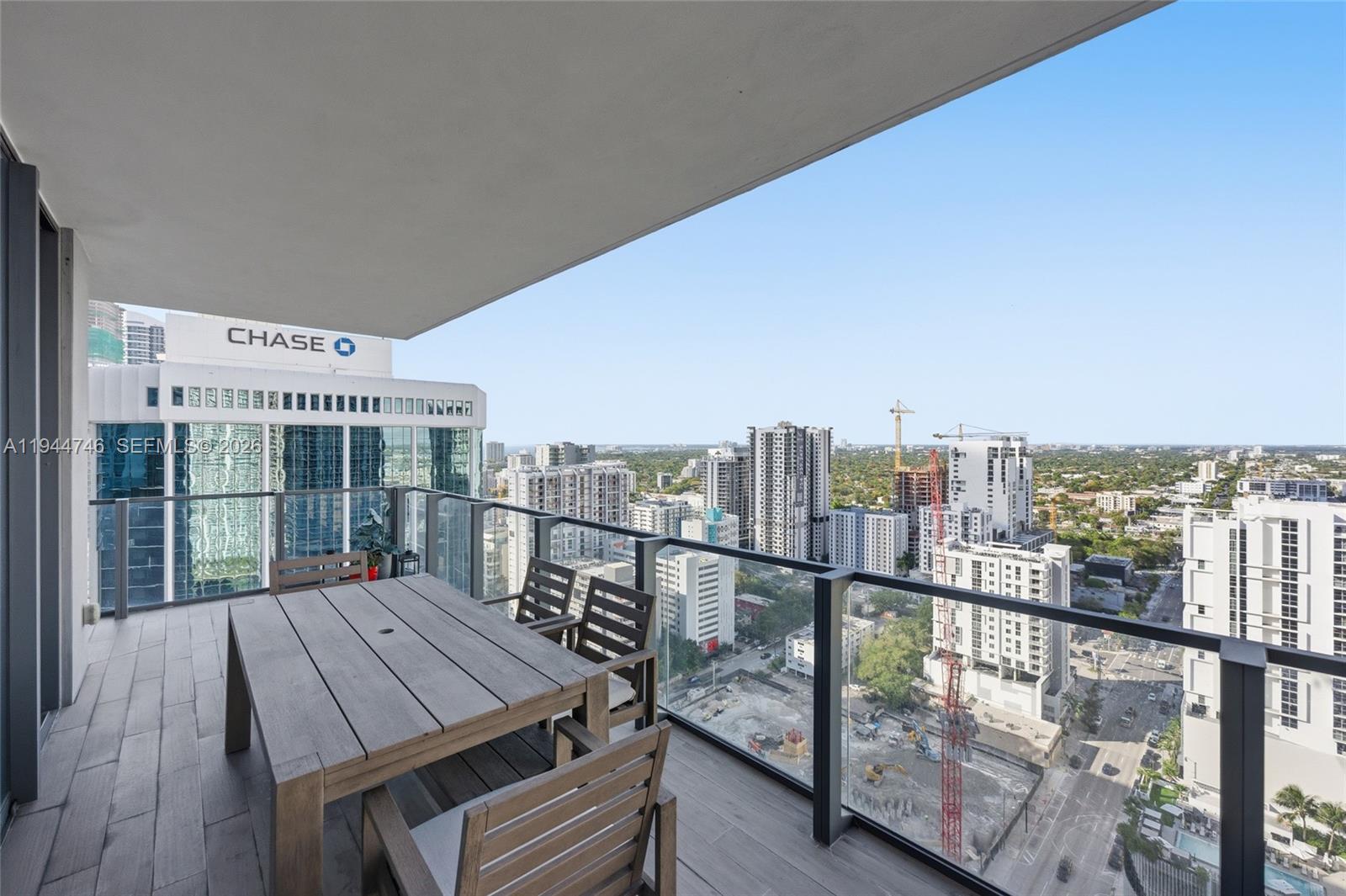 88 Southwest 7th Street, Unit 2302 Miami, FL 33130 - Photo 21 of 43 a view of a balcony with wooden floor and city view