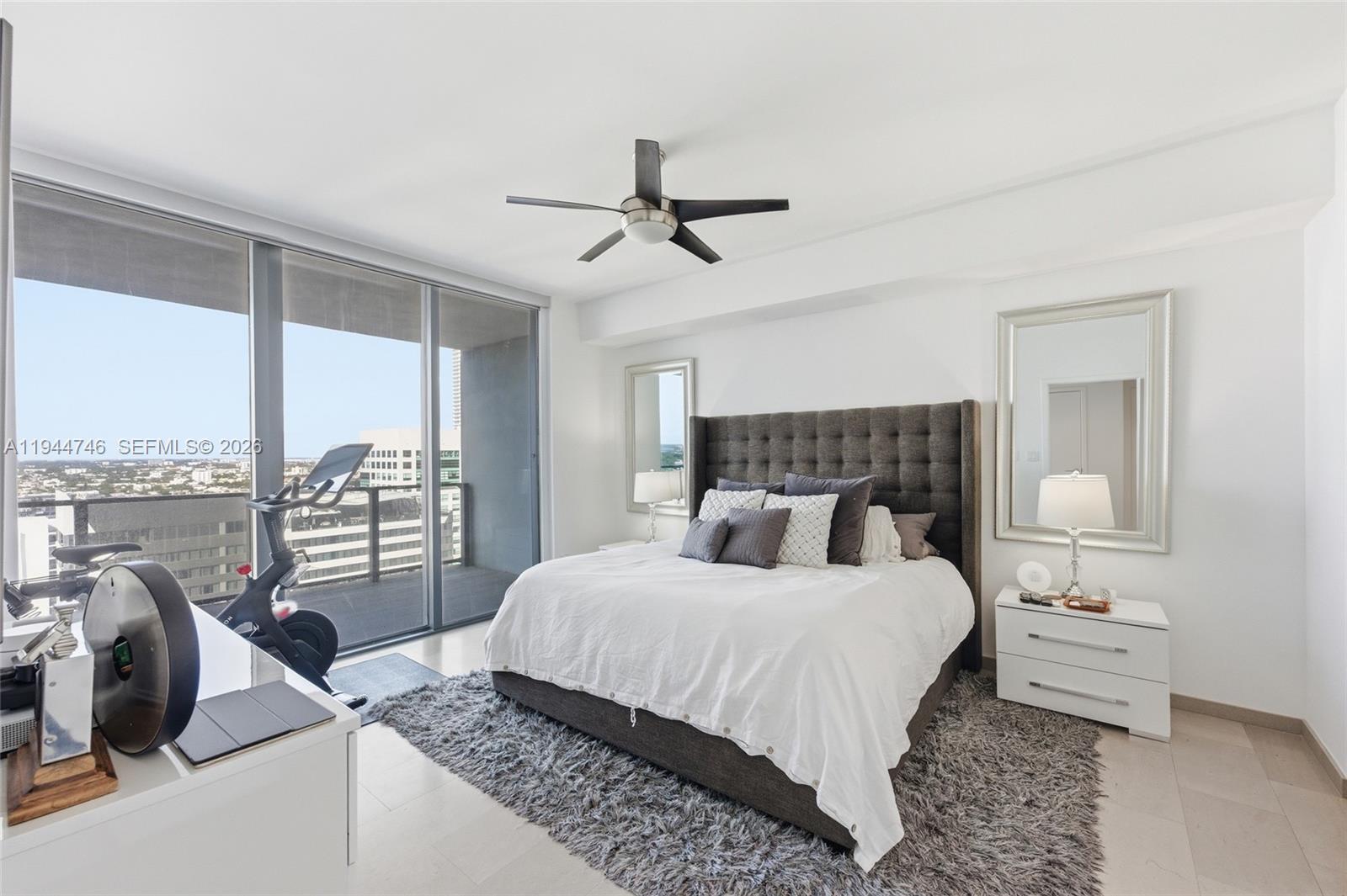 88 Southwest 7th Street, Unit 2302 Miami, FL 33130 - Photo 34 of 43 a bedroom with a large bed and a balcony