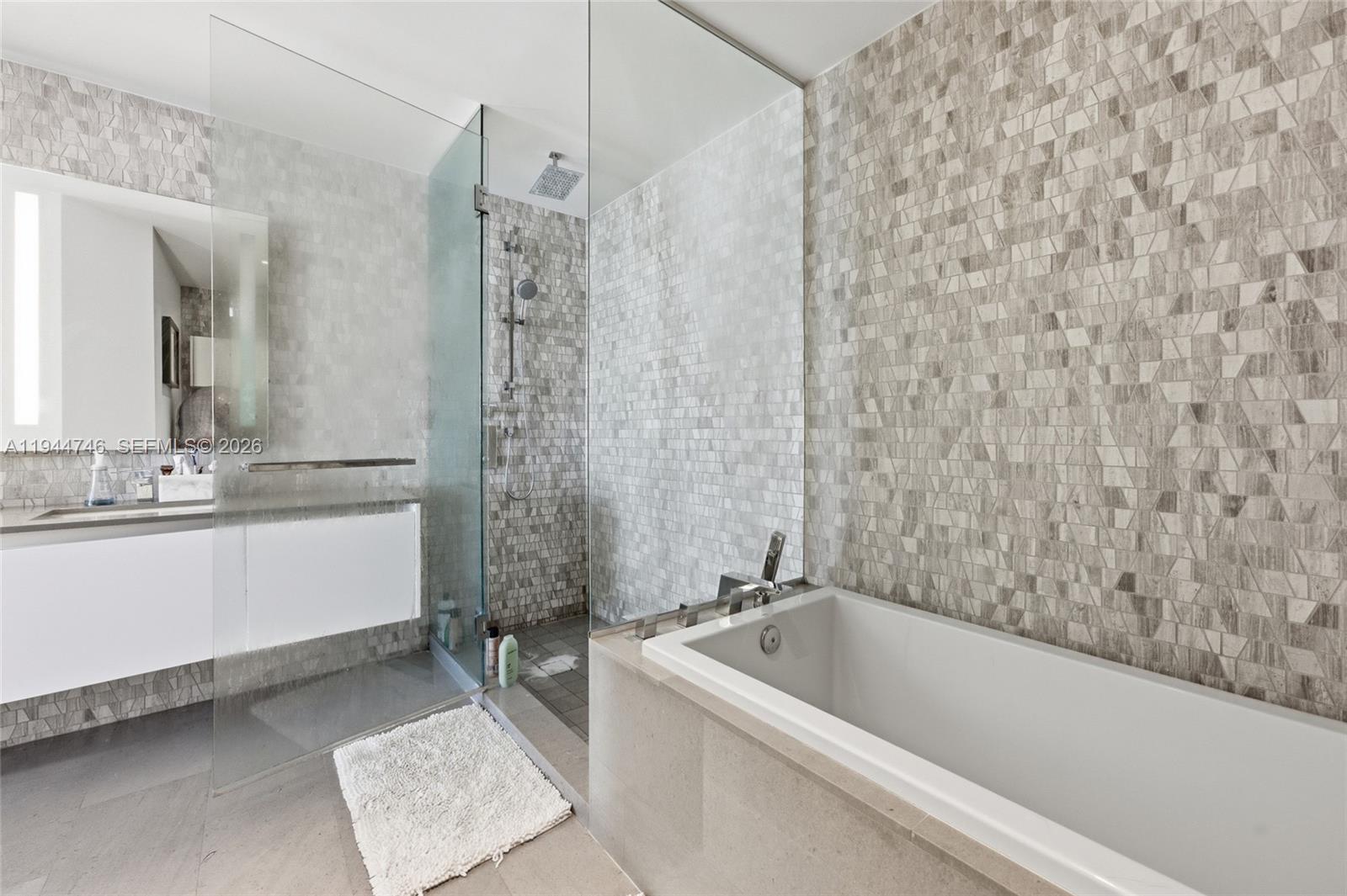 88 Southwest 7th Street, Unit 2302 Miami, FL 33130 - Photo 38 of 43 a bathroom with a bathtub and a sink