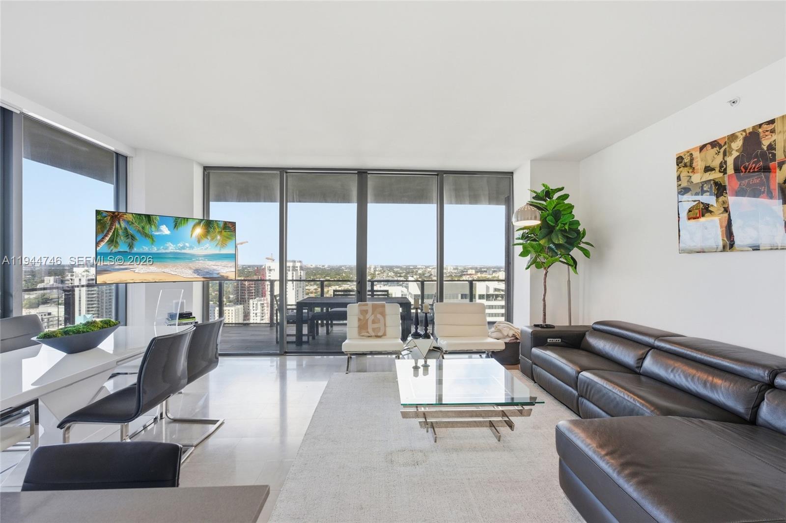 88 Southwest 7th Street, Unit 2302 Miami, FL 33130 - Photo 7 of 43 a living room with furniture and floor to ceiling window