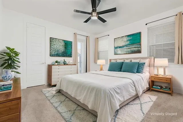 an empty room with fan and windows