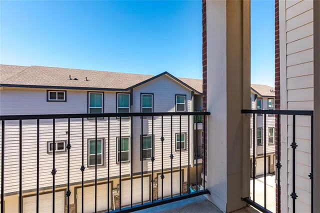 a view of a balcony with wooden floor and outdoor seating