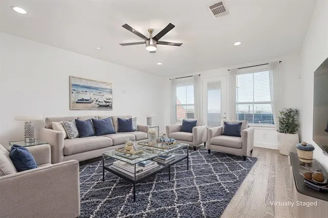 a living room with furniture and kitchen view