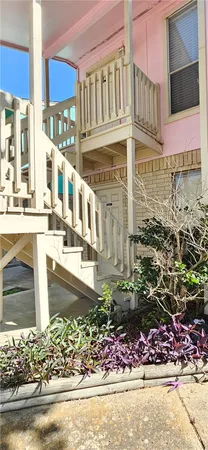 a view of a house with a yard and sitting area