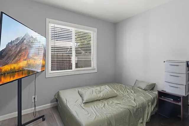 a bedroom with a bed and a window