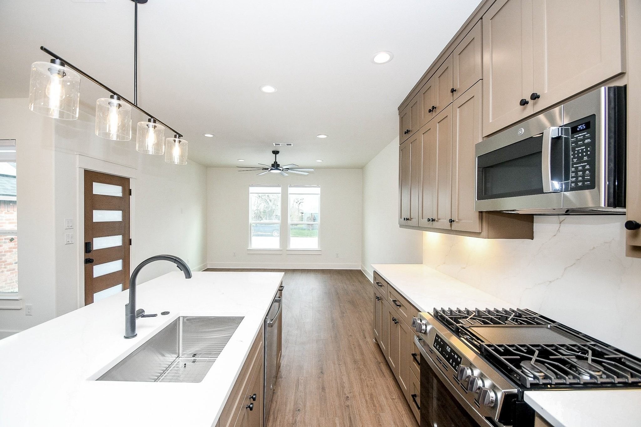 4101 Victoria, Unit B Dickinson, TX 77539 - Photo 13 of 33 a kitchen with stainless steel appliances granite countertop a stove a sink and a microwave