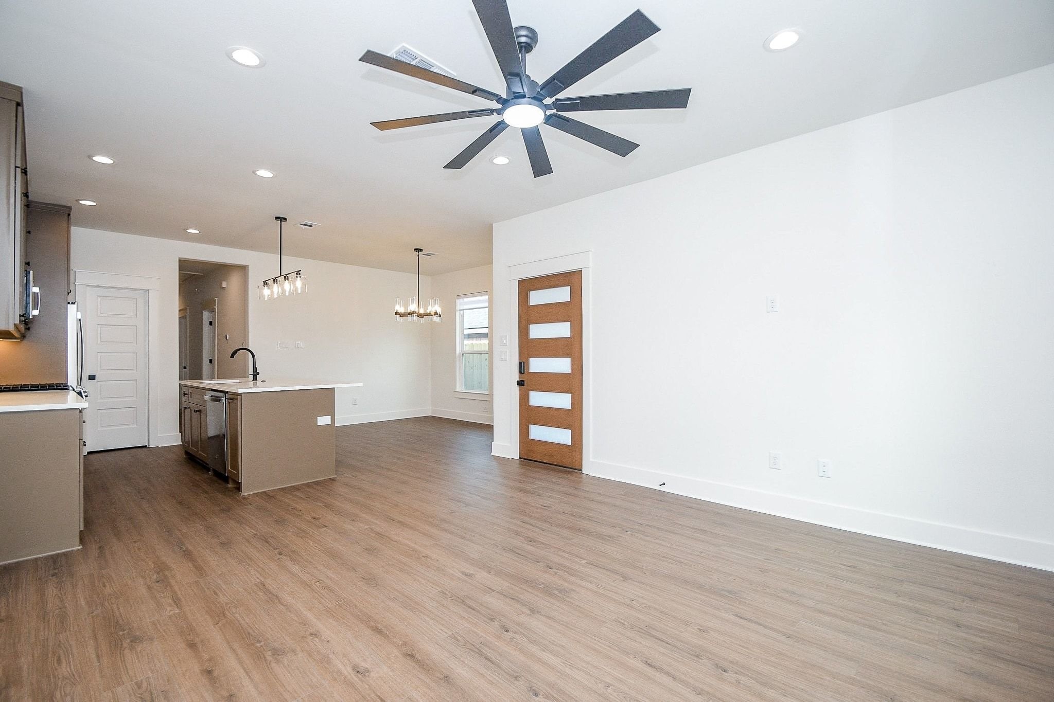 4101 Victoria, Unit B Dickinson, TX 77539 - Photo 7 of 33 a view of an empty room with a window and wooden floor