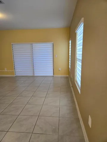 a view of a room with an empty space and a window