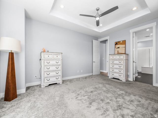 877 South Yarrow Drive Mapleton, UT 84664 - Photo 26 of 46 Bedroom featuring light gray carpeting, tray ceiling with recessed lighting, and a contemporary ceiling fan