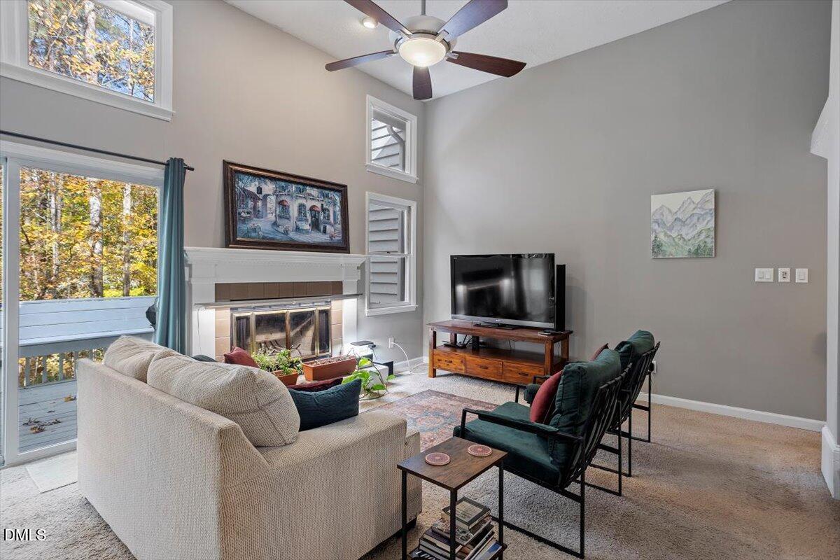 100 Hunting Chase, Unit 1D Cary, NC 27513 - Photo 19 of 33 a living room with furniture a fireplace and a flat screen tv