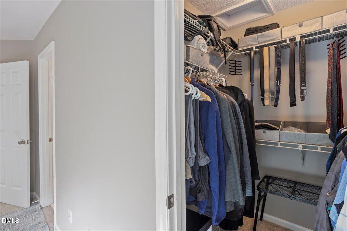 100 Hunting Chase, Unit 1D Cary, NC 27513 - Photo 26 of 33 a view of walk in closet with clothes and shoes