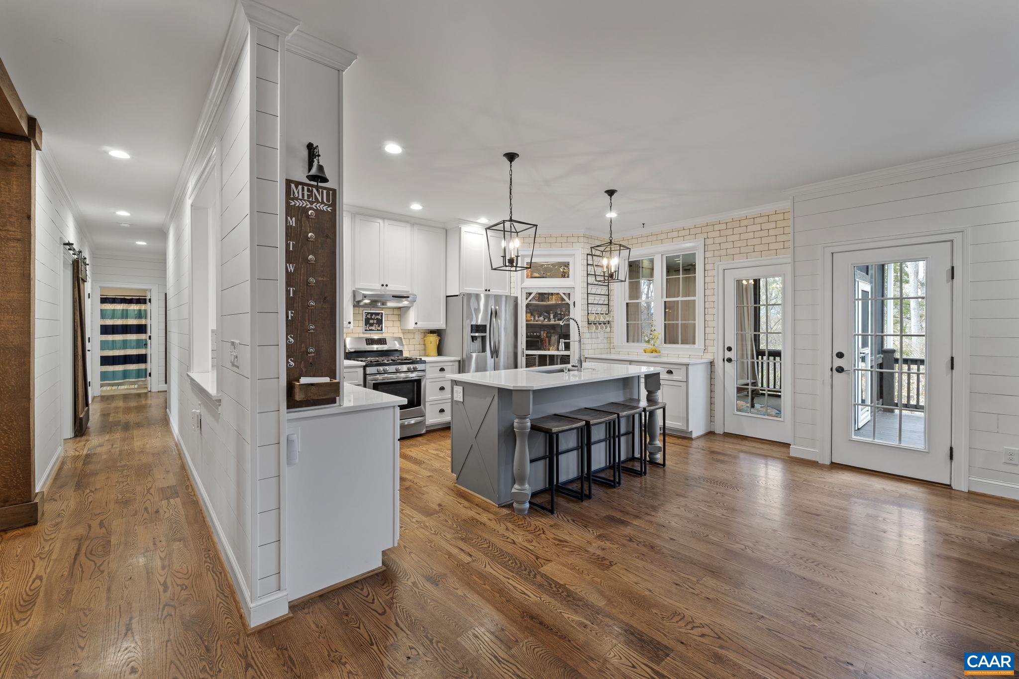 269 Devon Drive Ruckersville, VA 22968 - Photo 13 of 51 an open kitchen with white cabinets and stainless steel appliances