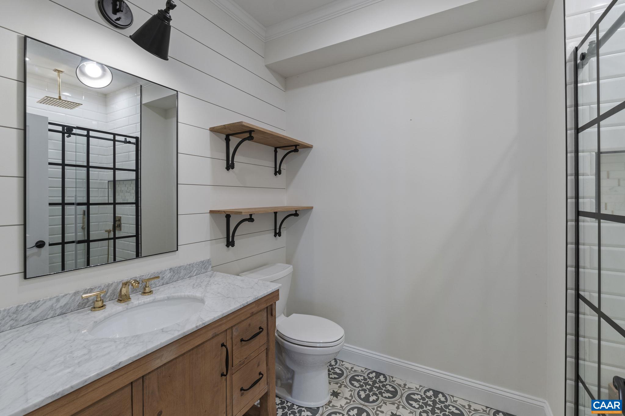 269 Devon Drive Ruckersville, VA 22968 - Photo 45 of 51 a bathroom with a granite countertop sink toilet and mirror