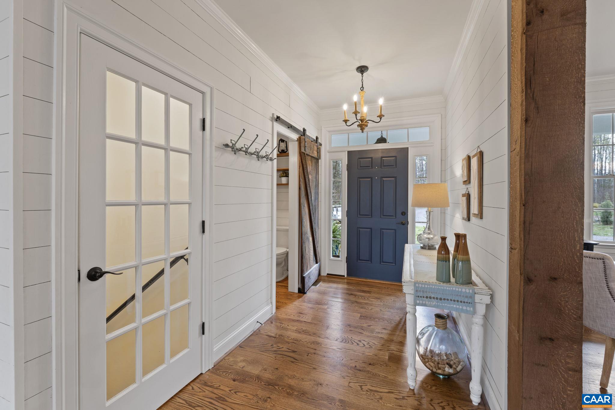 269 Devon Drive Ruckersville, VA 22968 - Photo 5 of 51 a view of a hallway with wooden floor and staircase