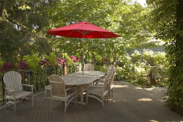 6 Upland Road West Arlington, MA 02474 - Photo 9 of 9 a view of a dining table and chairs under an umbrella