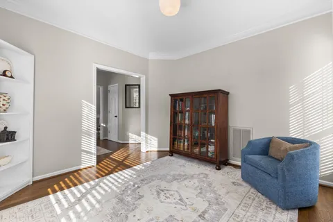 a living room with furniture a fireplace and a large window