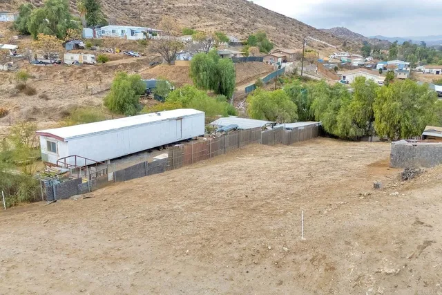 an aerial view of a house with a yard and lake view