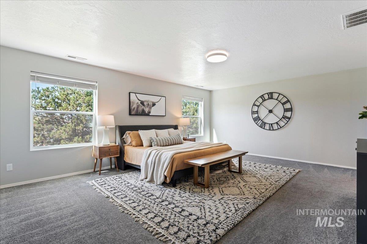 777 South Flintstone Avenue Meridian, ID 83642 - Photo 13 of 38 Bedroom with dark colored carpet and a textured ceiling