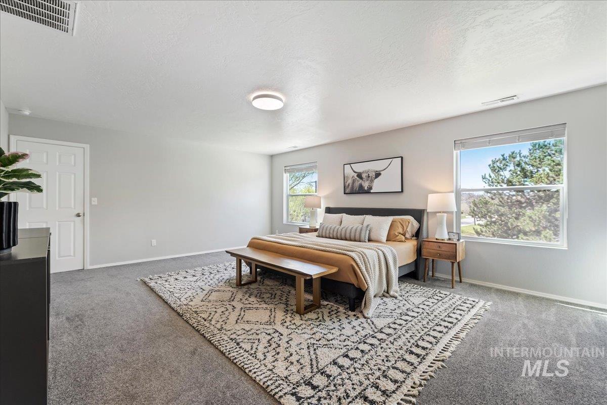 777 South Flintstone Avenue Meridian, ID 83642 - Photo 15 of 38 Carpeted bedroom with a textured ceiling and baseboards