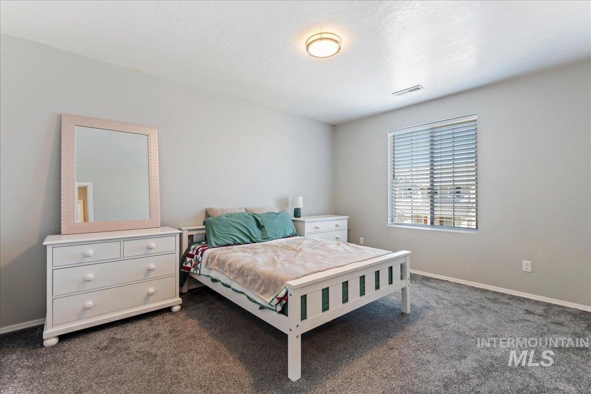 777 South Flintstone Avenue Meridian, ID 83642 - Photo 16 of 38 Bedroom featuring dark carpet