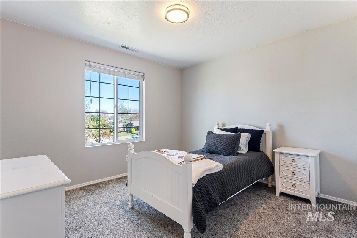 777 South Flintstone Avenue Meridian, ID 83642 - Photo 17 of 38 Carpeted bedroom featuring baseboards