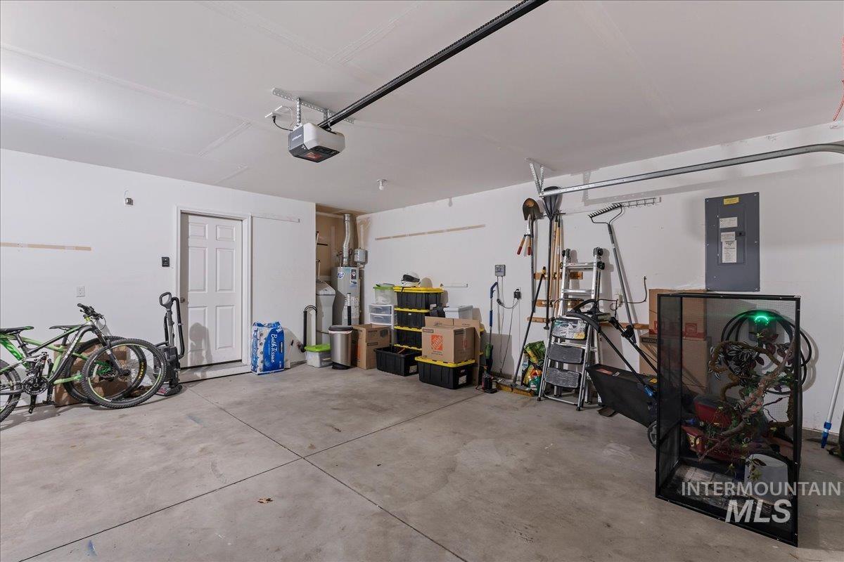 777 South Flintstone Avenue Meridian, ID 83642 - Photo 29 of 38 Garage with electric panel, water heater, and a garage door opener
