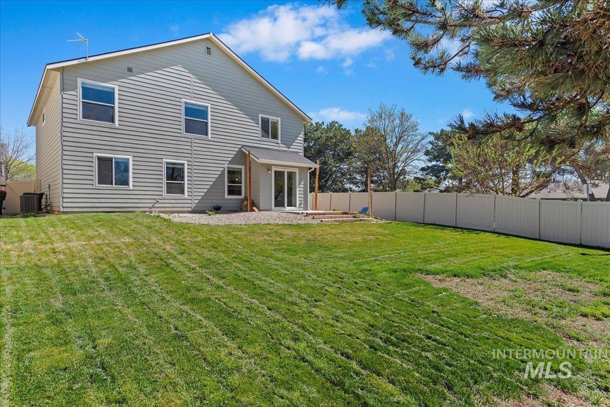 777 South Flintstone Avenue Meridian, ID 83642 - Photo 30 of 38 Rear view of house with a fenced backyard and a patio