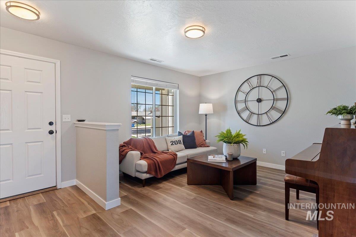 777 South Flintstone Avenue Meridian, ID 83642 - Photo 3 of 38 Living room with baseboards and light wood-style floors
