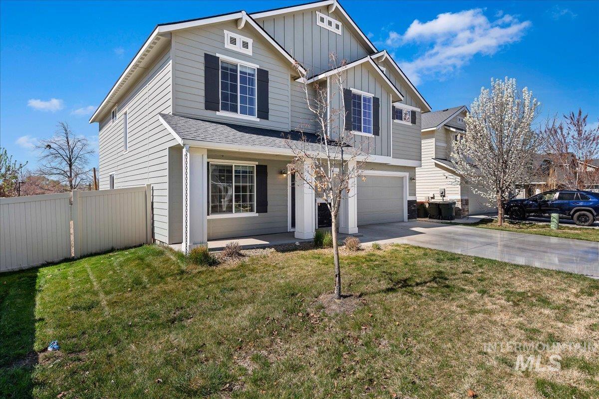 777 South Flintstone Avenue Meridian, ID 83642 - Photo 35 of 38 View of front facade featuring board and batten siding, an attached garage, concrete driveway, and a gate