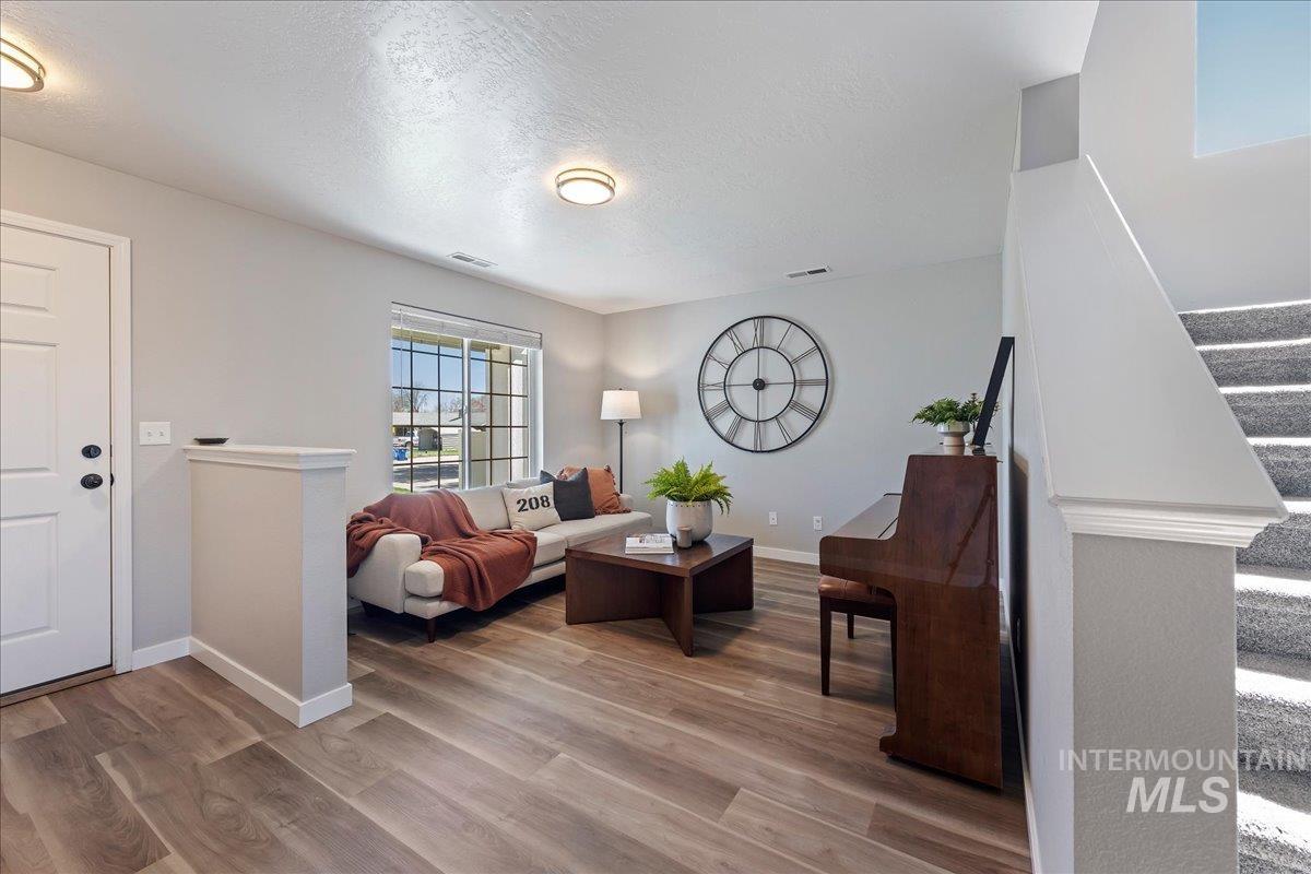 777 South Flintstone Avenue Meridian, ID 83642 - Photo 6 of 38 Living room with light wood-style flooring and a textured ceiling