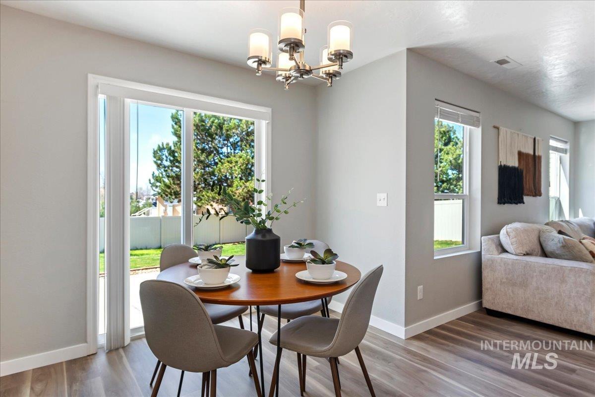 777 South Flintstone Avenue Meridian, ID 83642 - Photo 10 of 38 Dining area featuring wood finished floors and hanging lights