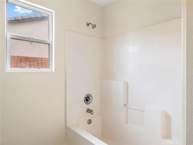 a bathroom with a granite countertop toilet a sink and a bathtub