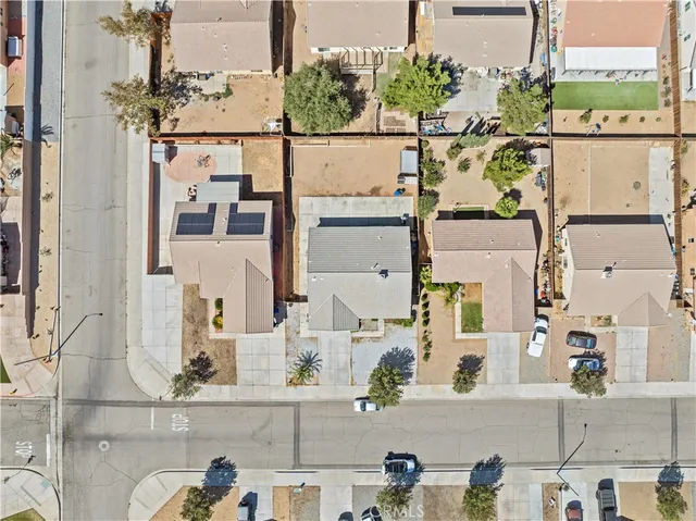 a view of house with outdoor space and trees in the background