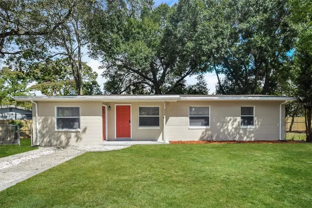 a front view of house with yard and green space