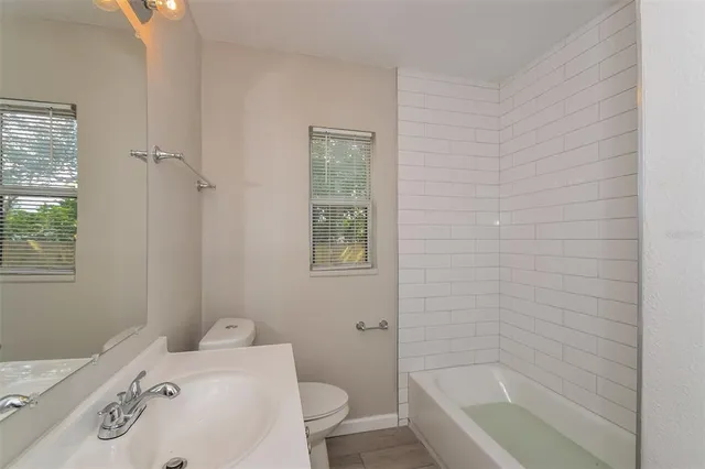 a bathroom with a bathtub and toilet