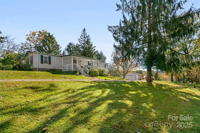 a view of a house with swimming pool and yard
