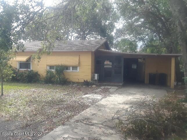 3920 Dixie Highway Northeast Palm Bay, FL 32905 - Photo 8 of 28 a view of a small house with a yard and garage