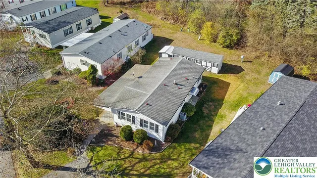 an aerial view of a house with a yard