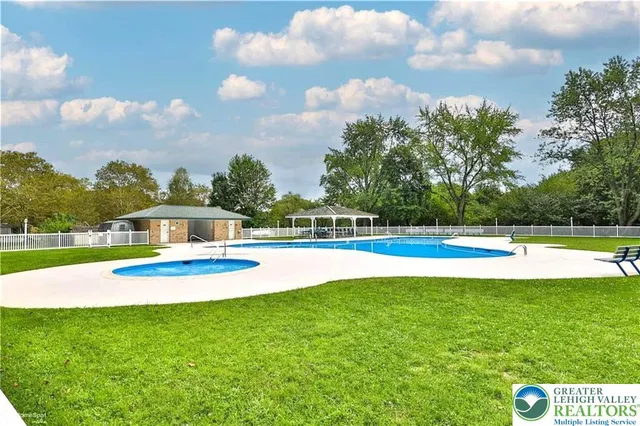 a view of a swimming pool with a yard