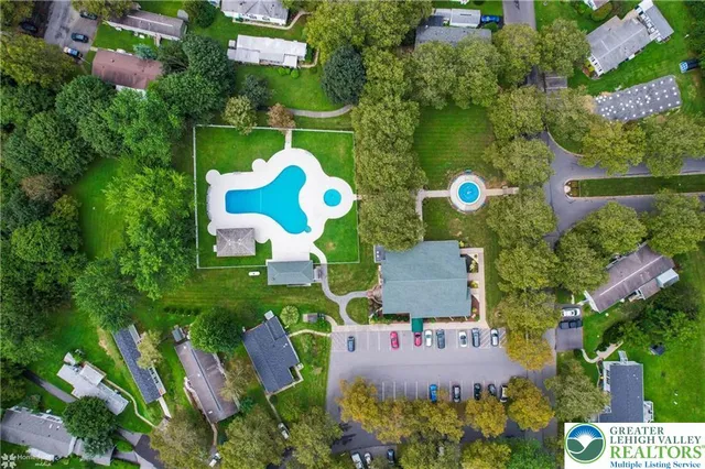 an aerial view of house with yard swimming pool and outdoor seating