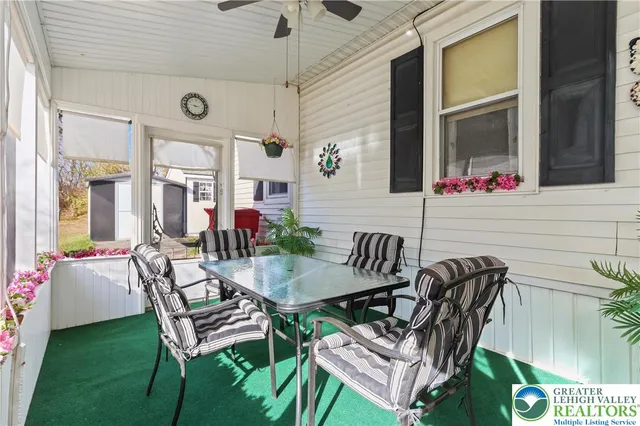 a view of a patio with table and chairs and potted plants